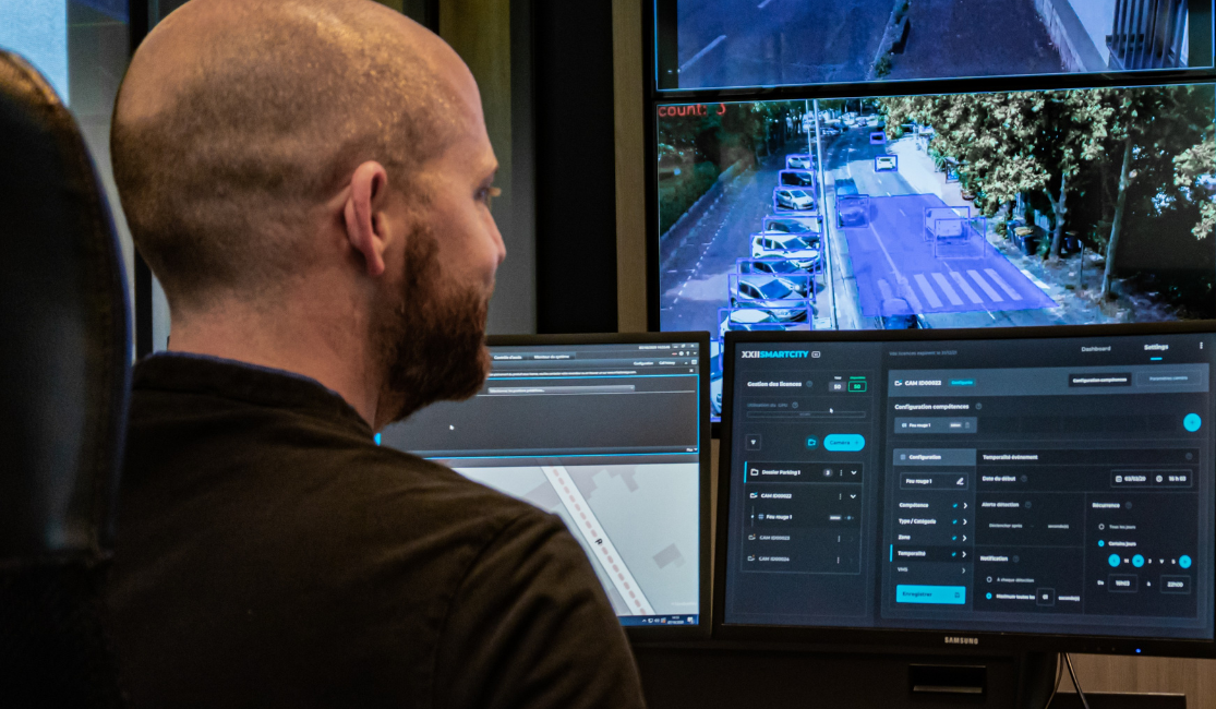 Collaborator in front of several screens