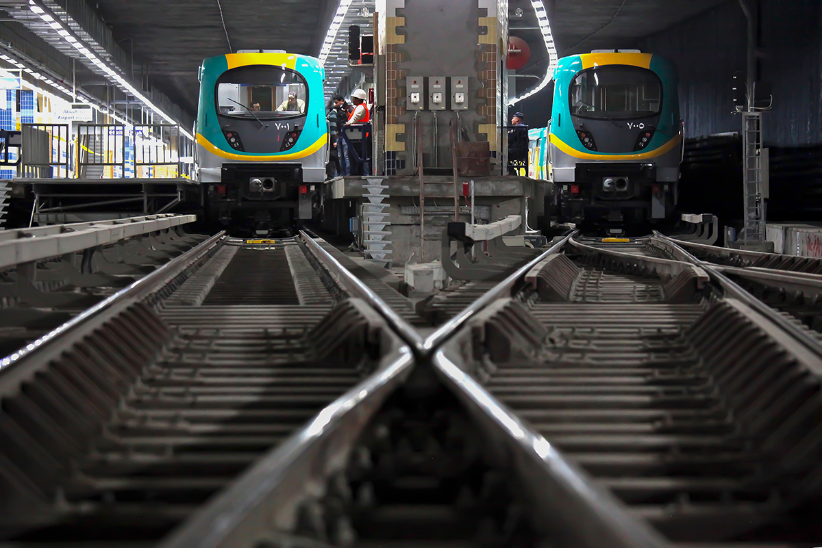 Two modern trains in underground station.