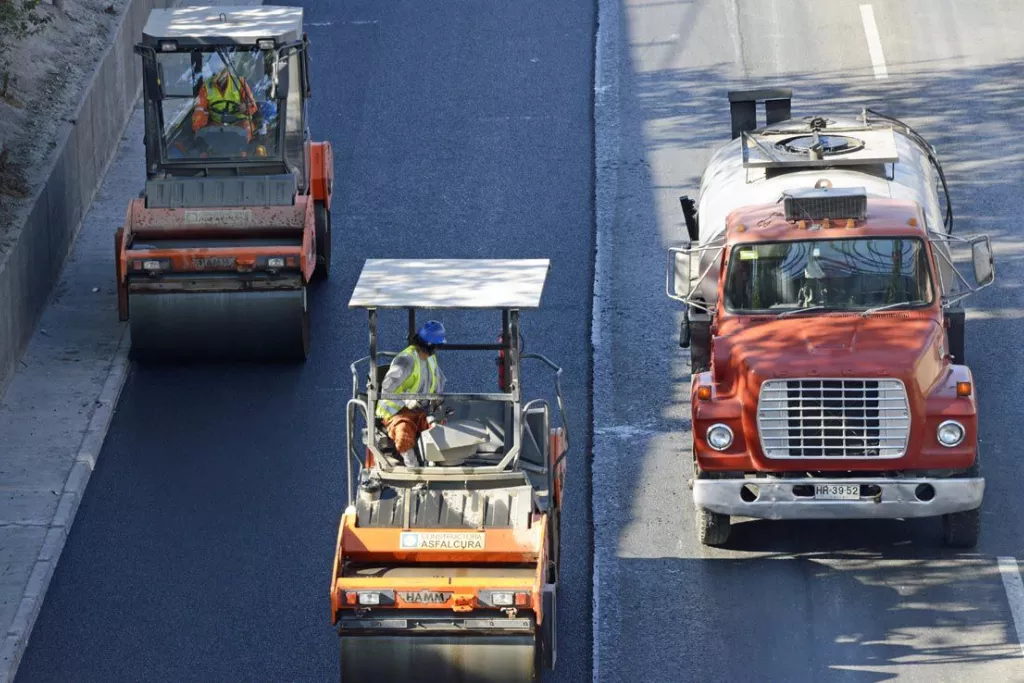 Road construction with two rollers and a water truck