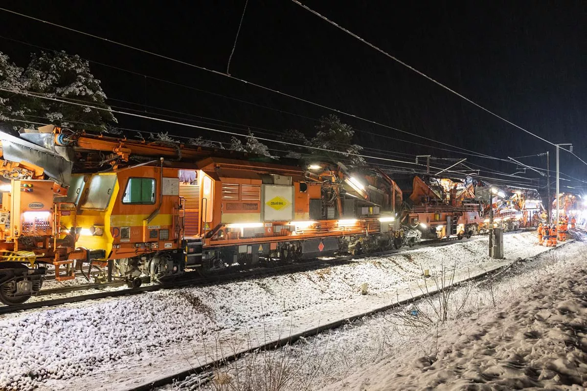Orange factory train in action during the night