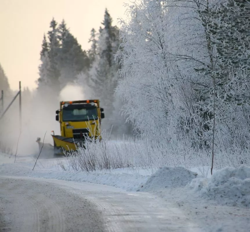 Snow remover in action in a snowy forest