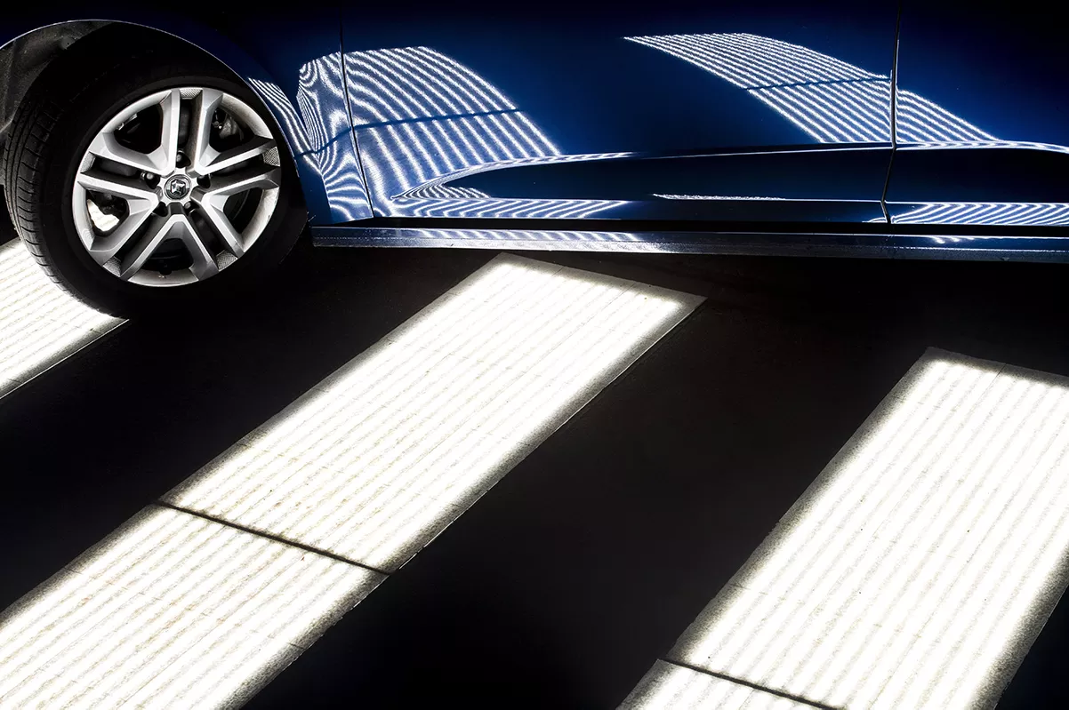 pedestrian crossing and blue car