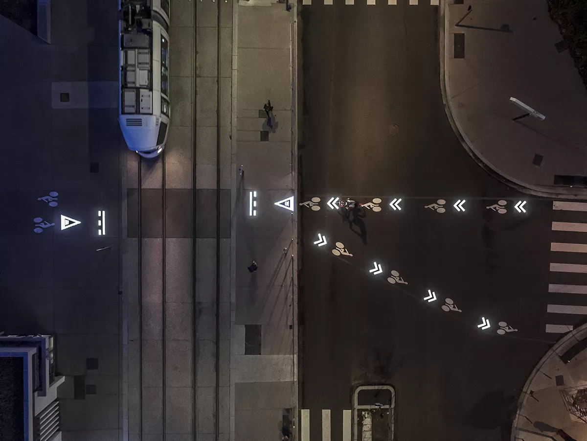 View from above, illuminated horizontal sign for cyclists