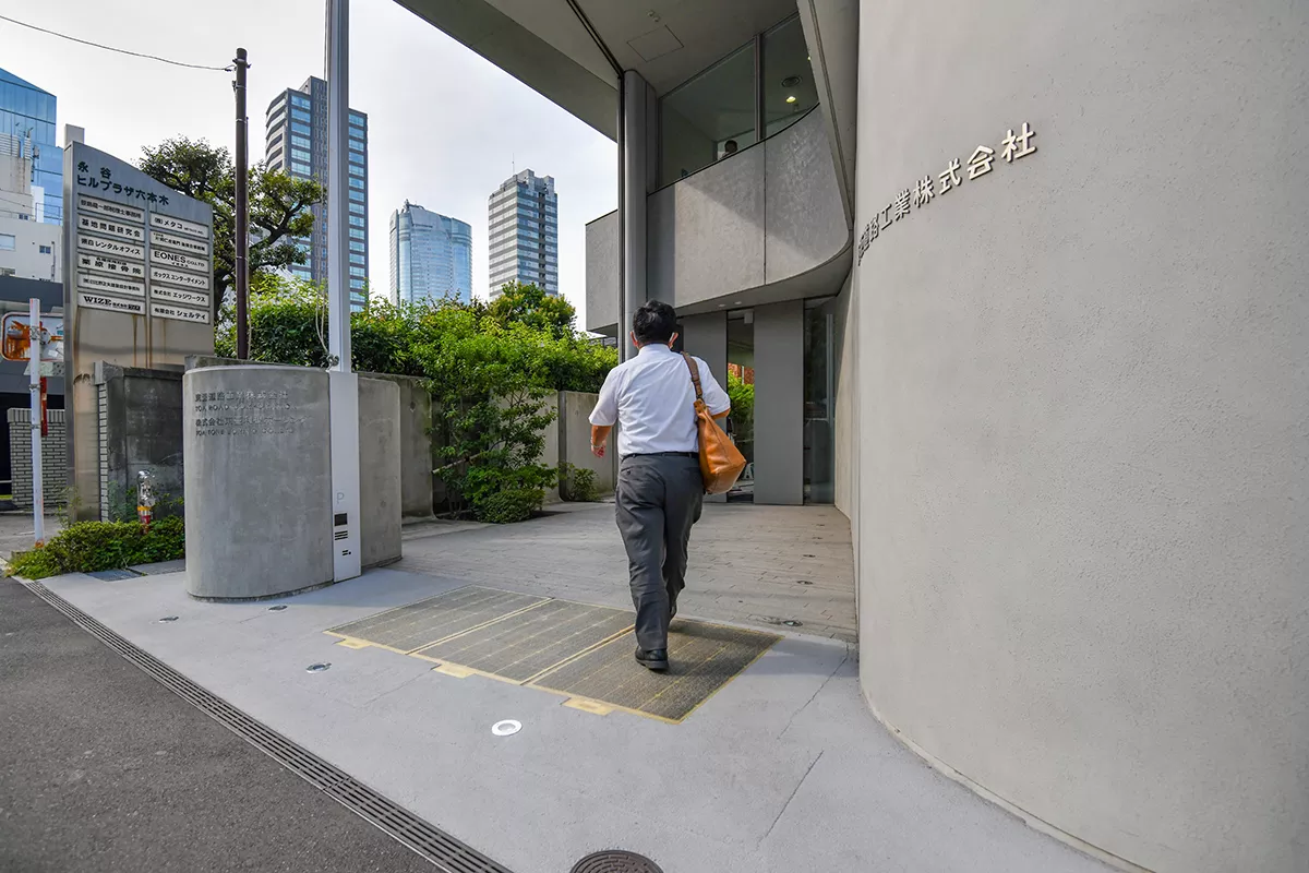 Man walking into a building in an urban area