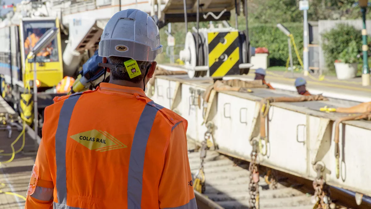 Collaborator seen from behind looking at the ongoing construction site