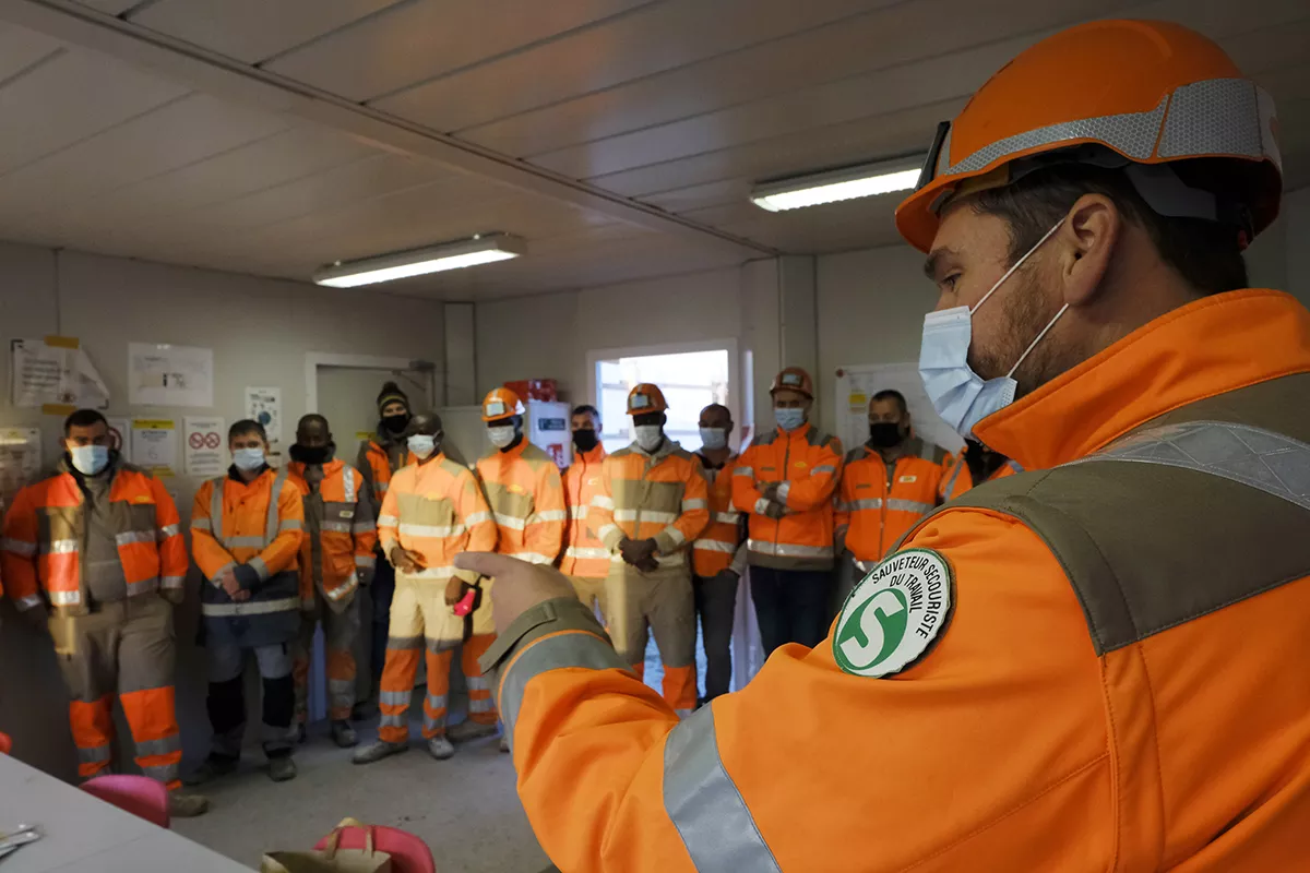 Team meeting led by a work rescuer before going to the construction site